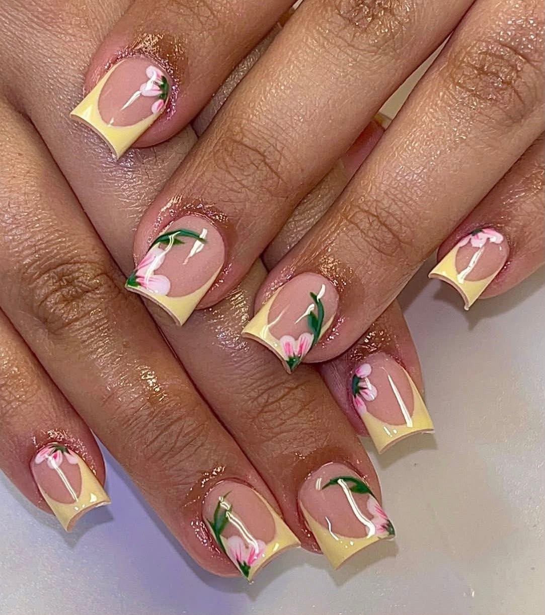Short square nails with pink, yellow and green curved details