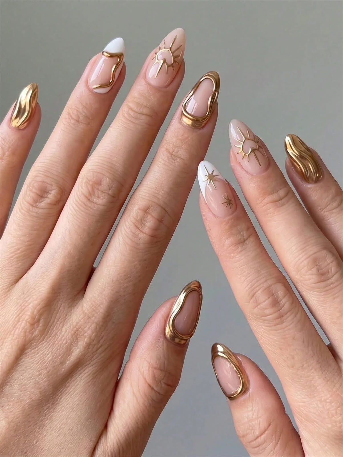 Neutral almond nails with sculpted gold chrome details
